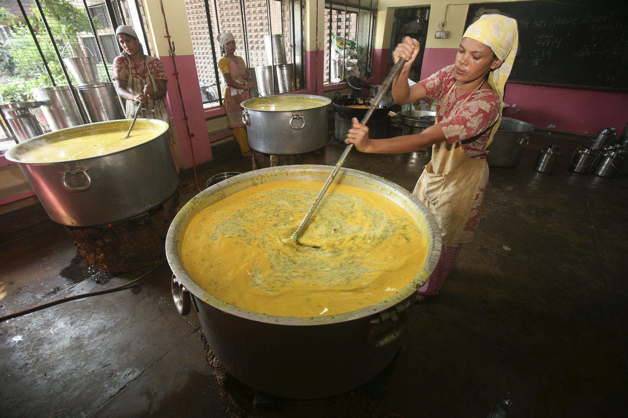 Workers prepare a midday meal for school children in the northern Indian city of Chandigarh, India. REUTERS/Ajay Verma