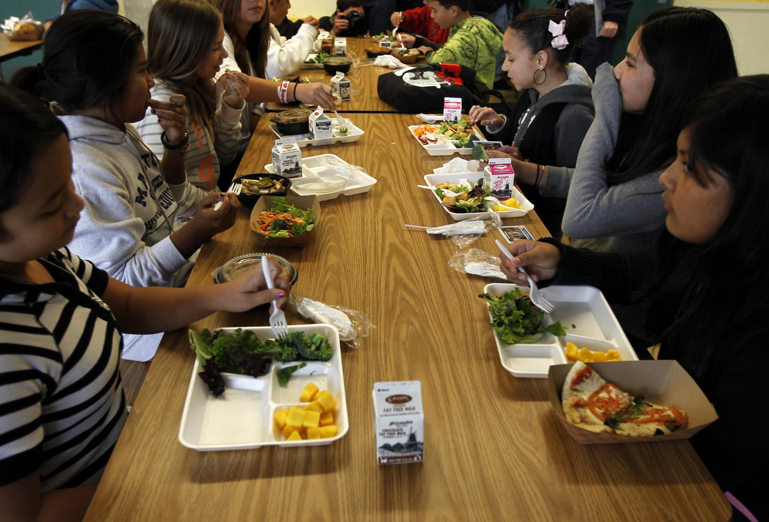 Students sit down to eat a healthy lunch at Marston Middle School.