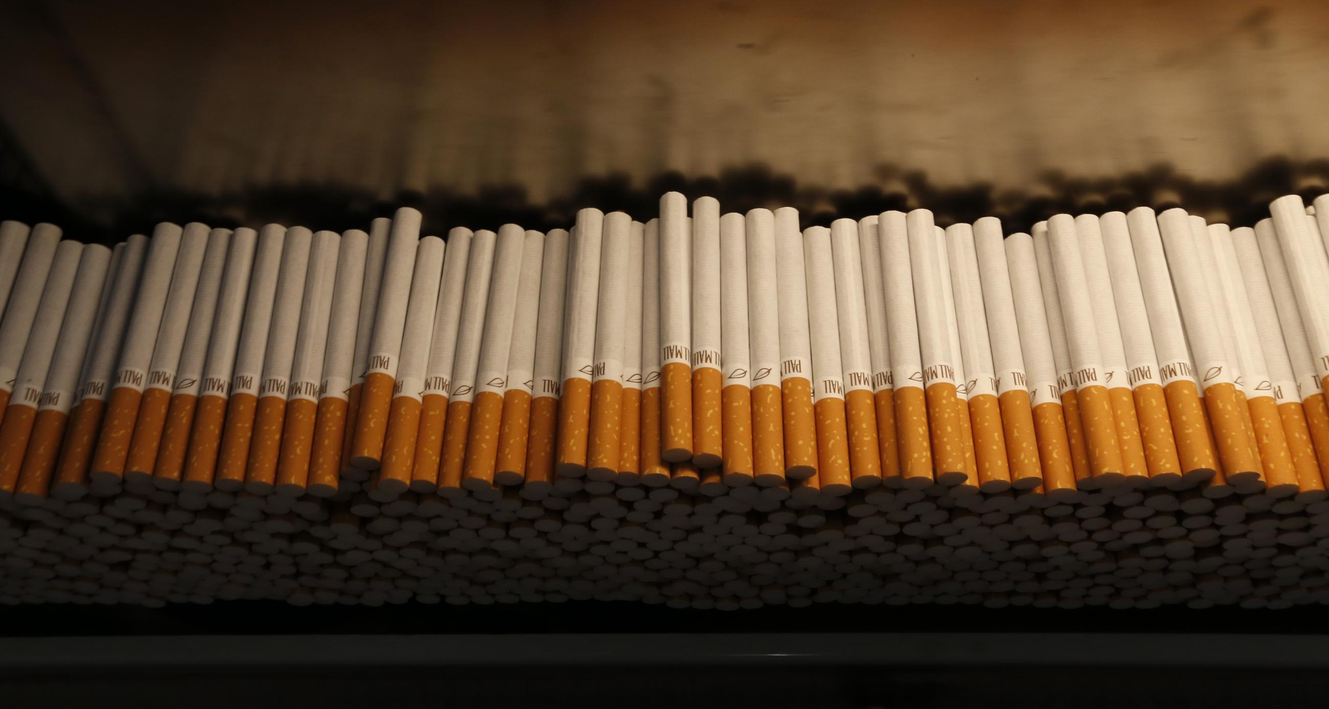 Cigarettes are piled during the manufacturing process in the British American Tobacco Cigarette Factory.