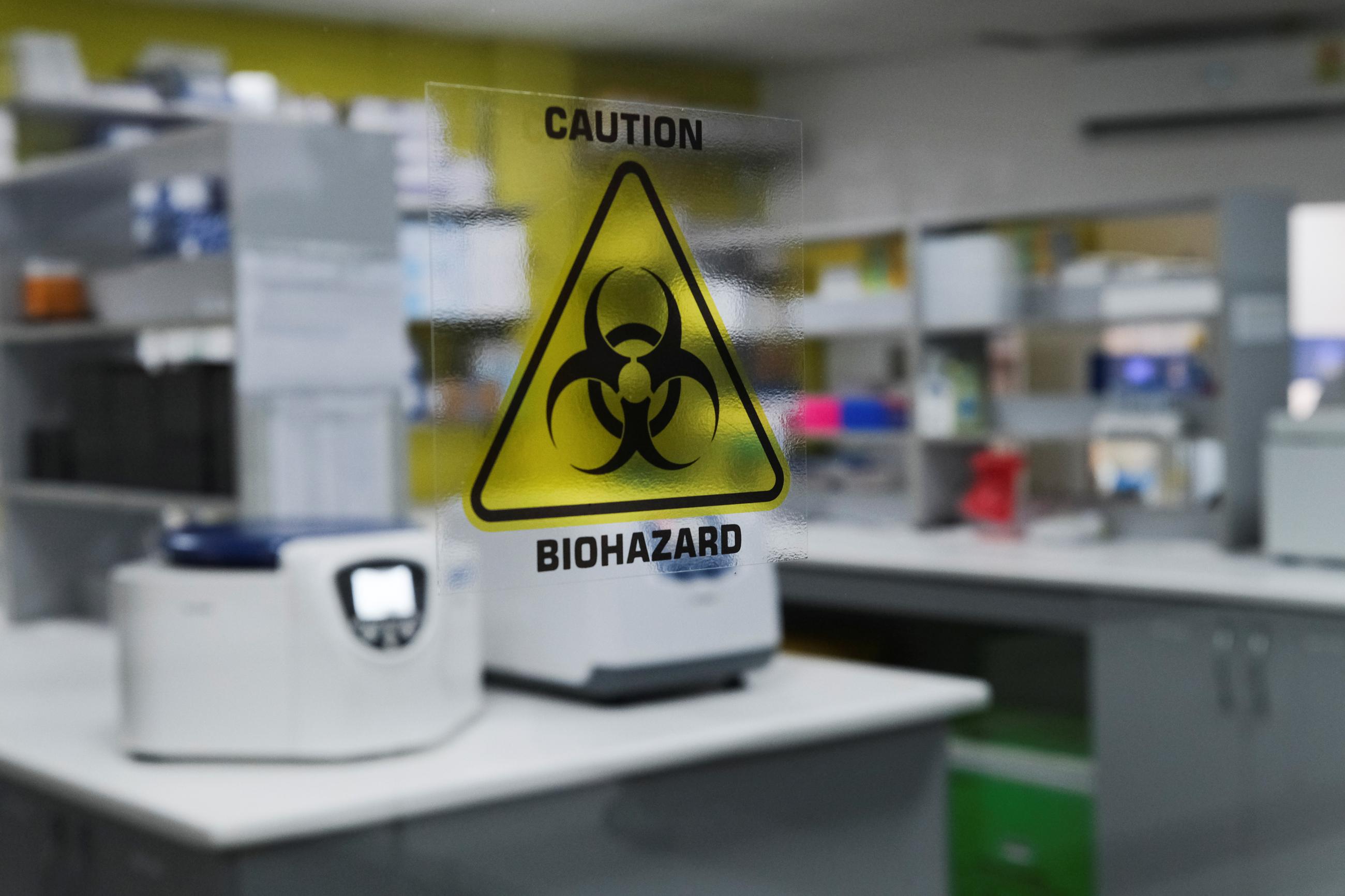 A biohazard warning sign is displayed at the Yemaachi Biotechnology cancer research laboratory.