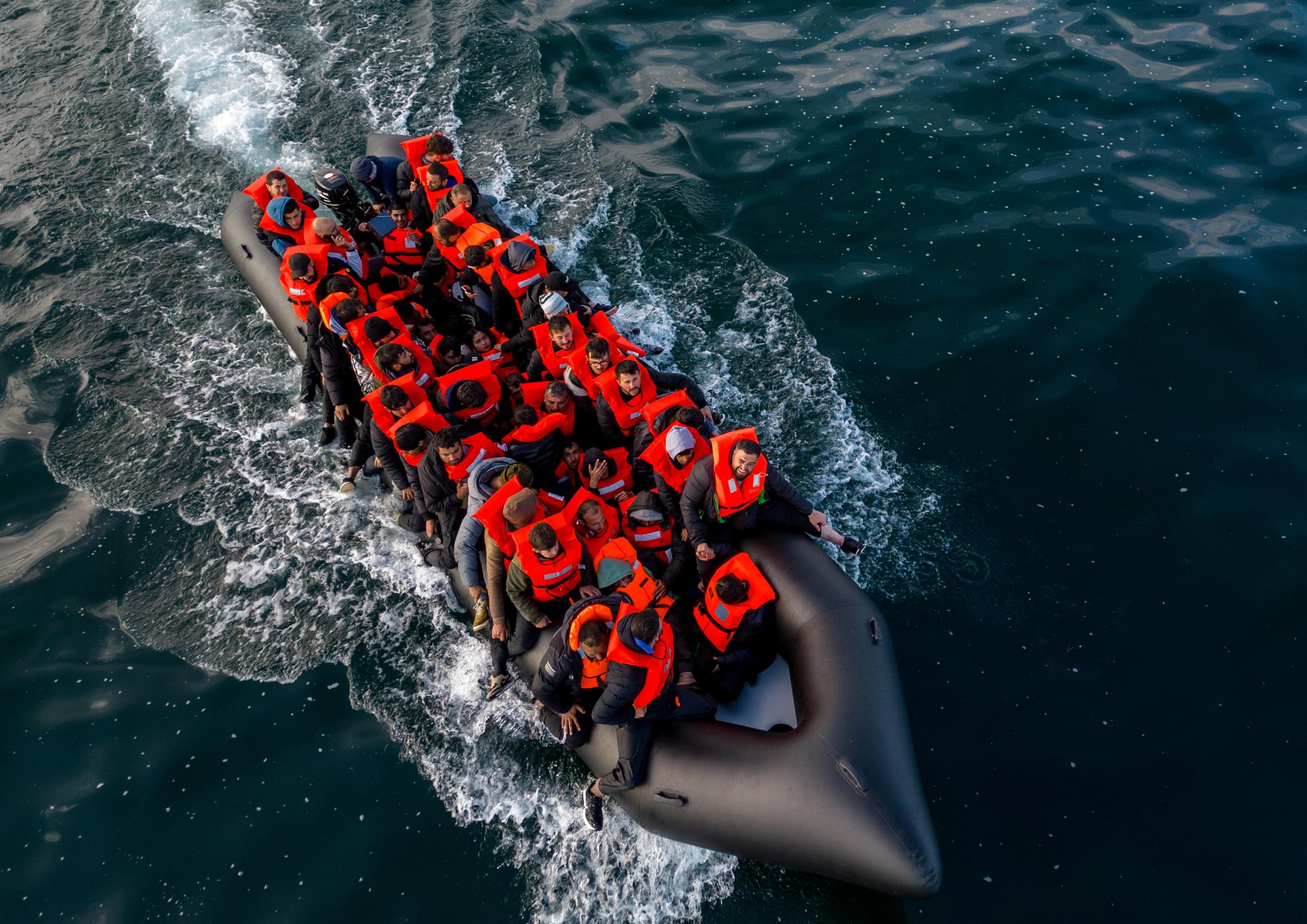 An inflatable dinghy carrying migrants makes its way toward England.