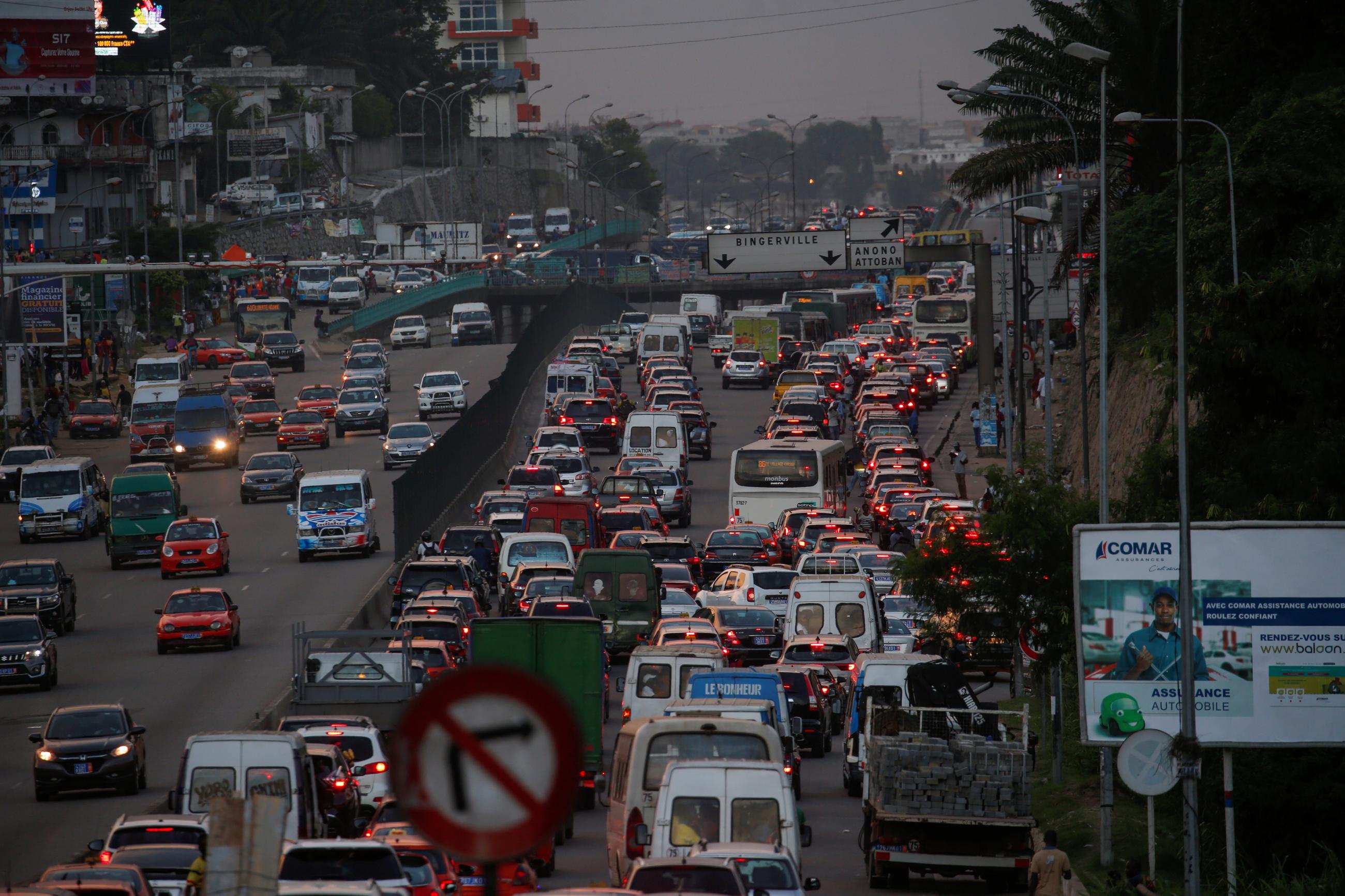Vehicles are stuck in a traffic jam at dusk.