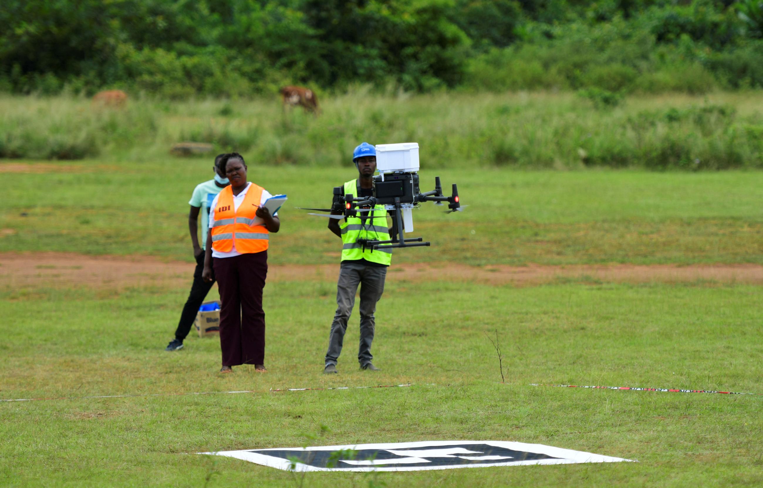 Joan Akullo, project coordinator for Medical Drones Project, monitors a drone.