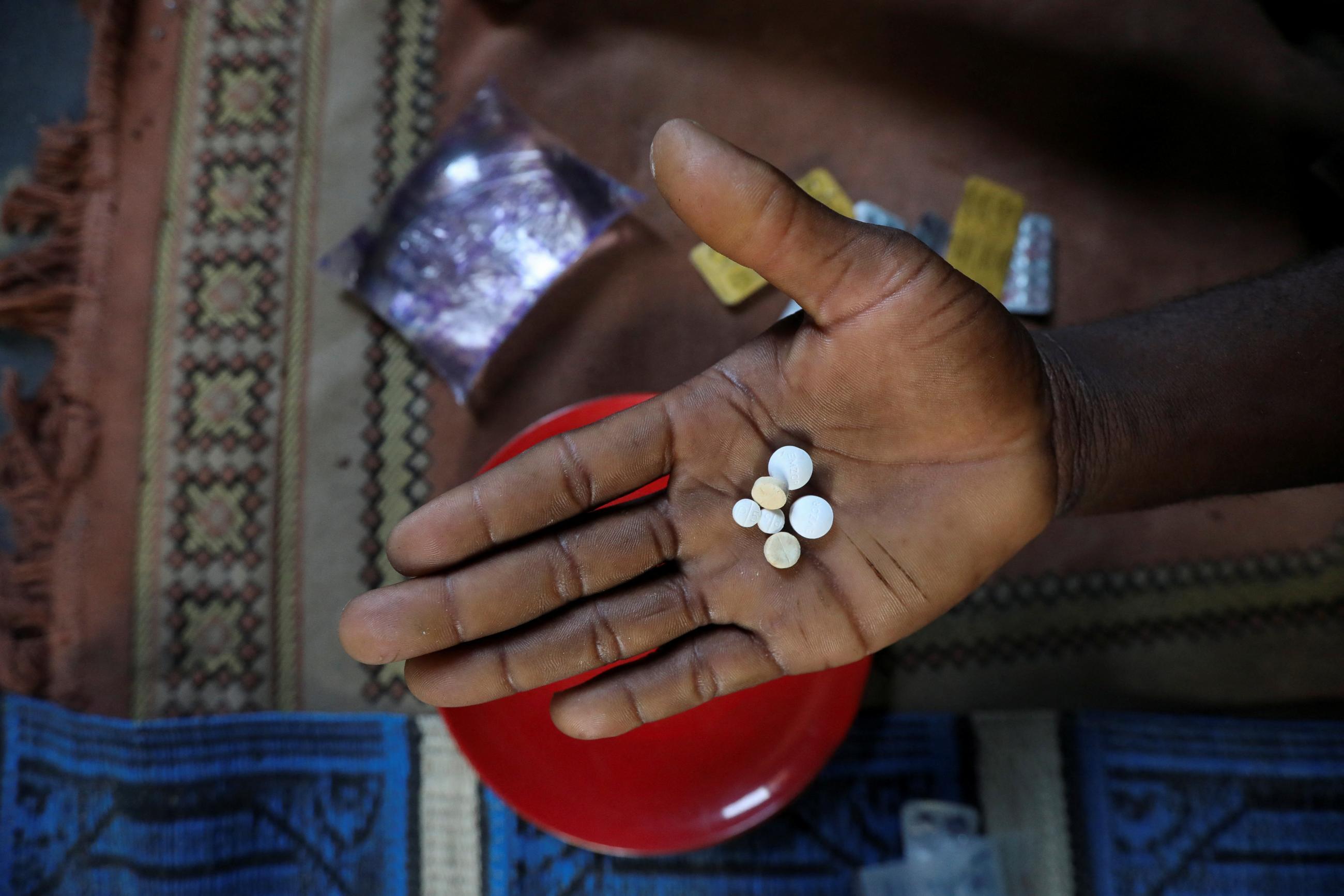 Sodiq Ajibade, who suffers from bouts of asthma attacks, displays his medication.