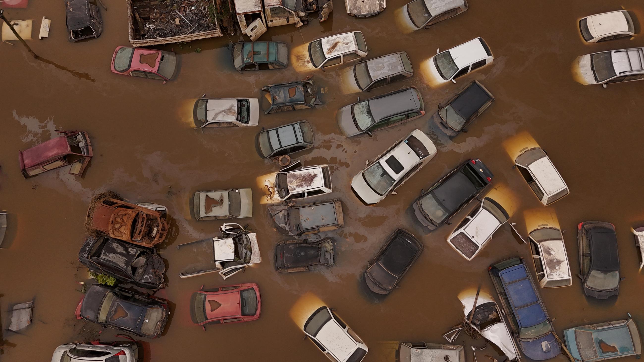 A drone view shows cars under water at a courtyard of the State Traffic Department during floods.