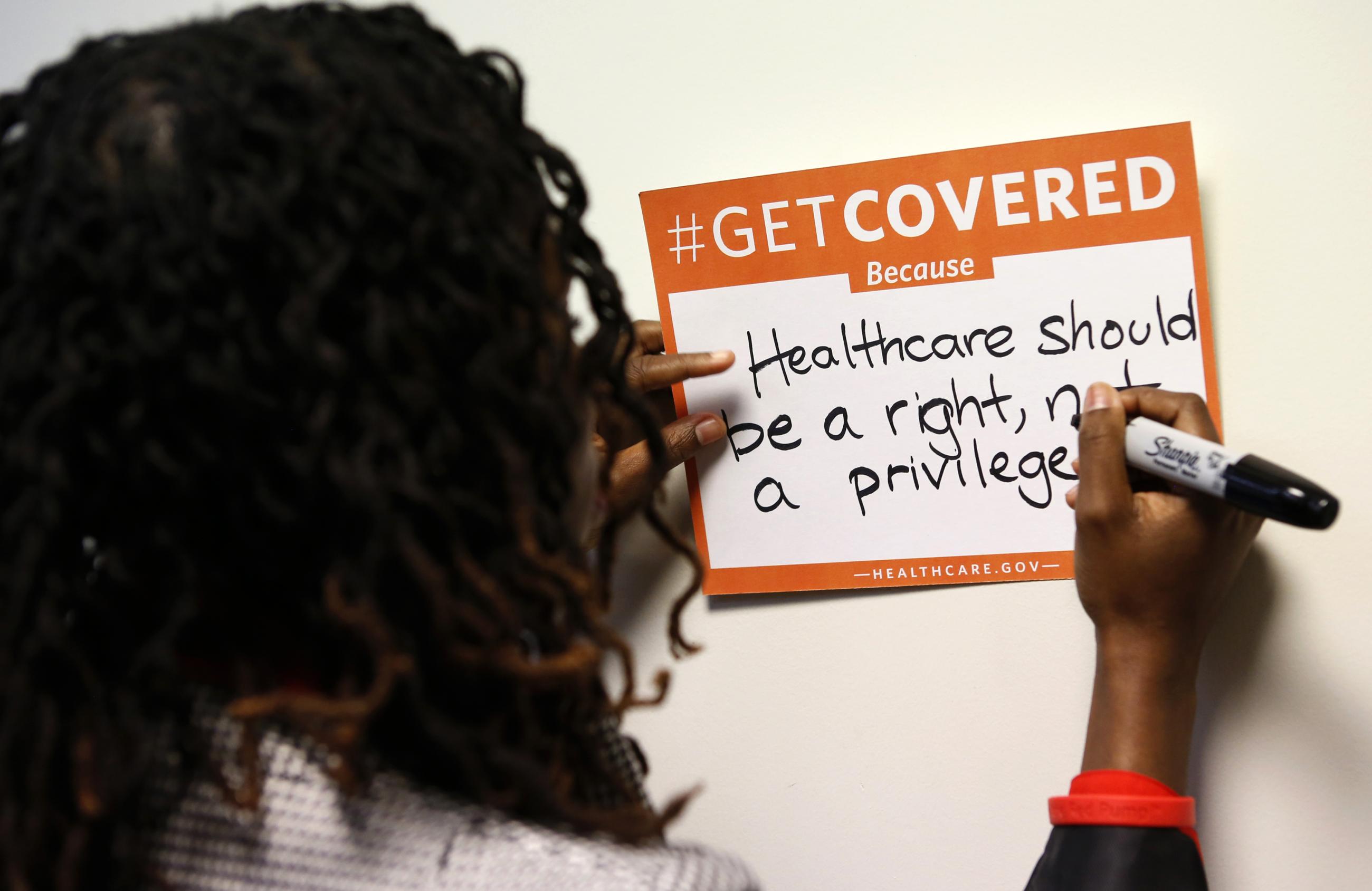 A woman fills out her thoughts on the Affordable Care Act at the White House Youth Summit on the Affordable Care Act.