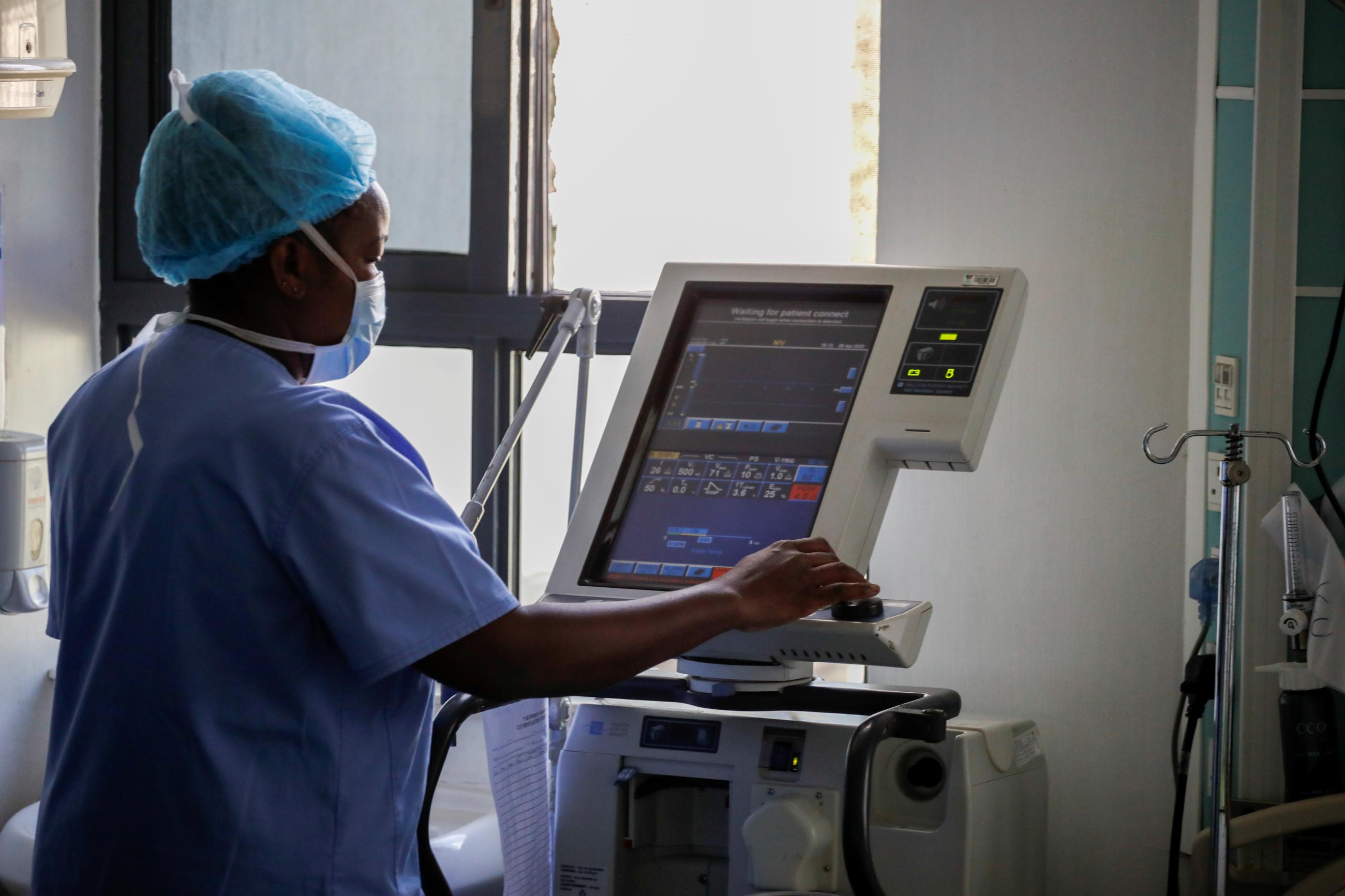 A nurse demonstrates how to activate a respirator during the COVID-19 outbreak, at the Karen hospital.