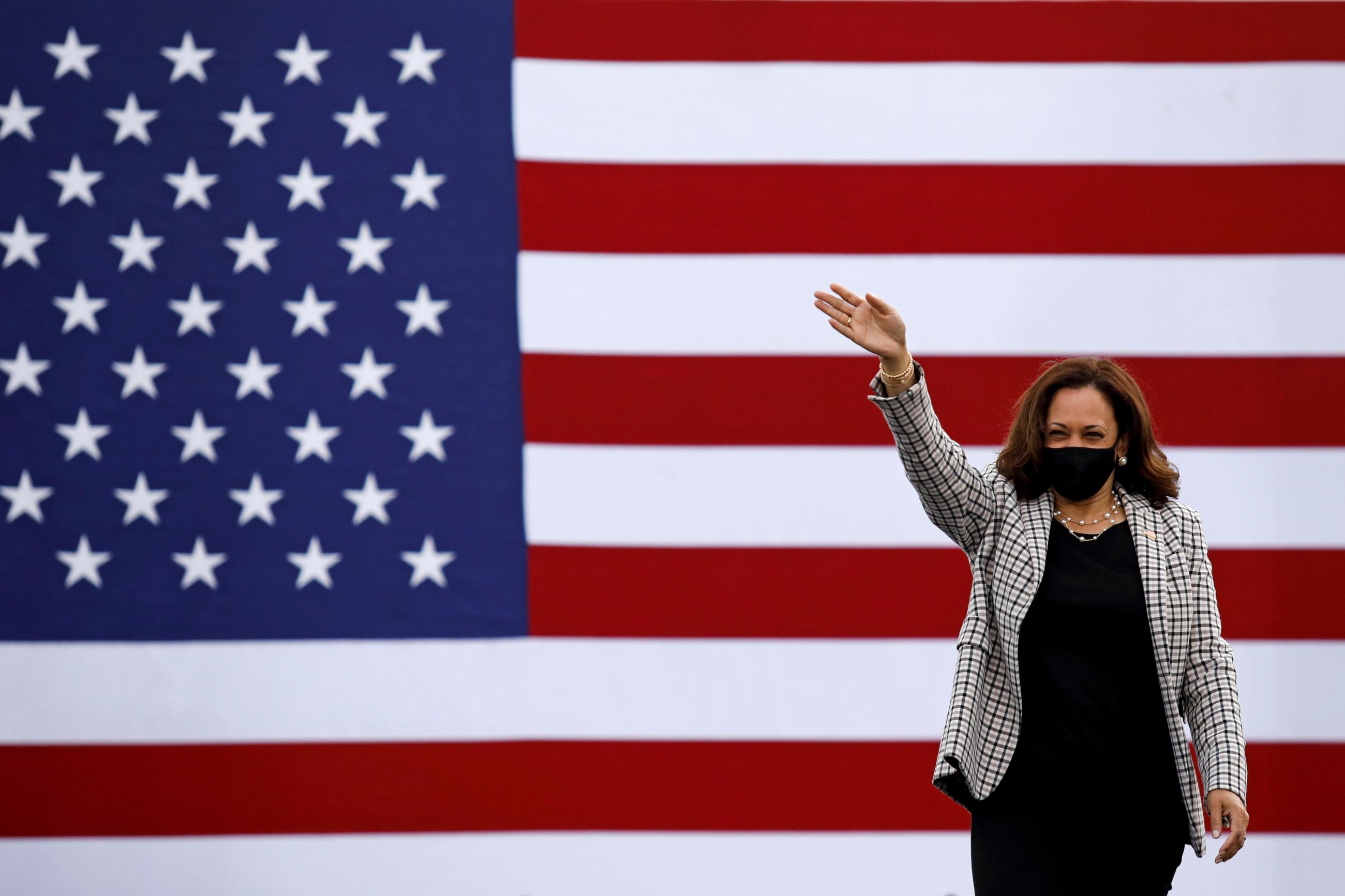 Kamala Harris waves supporters as she arrives for a campaign drive-in rally at Palm Beach State College in West Palm Beach, Florida, U.S., October 31, 2020.