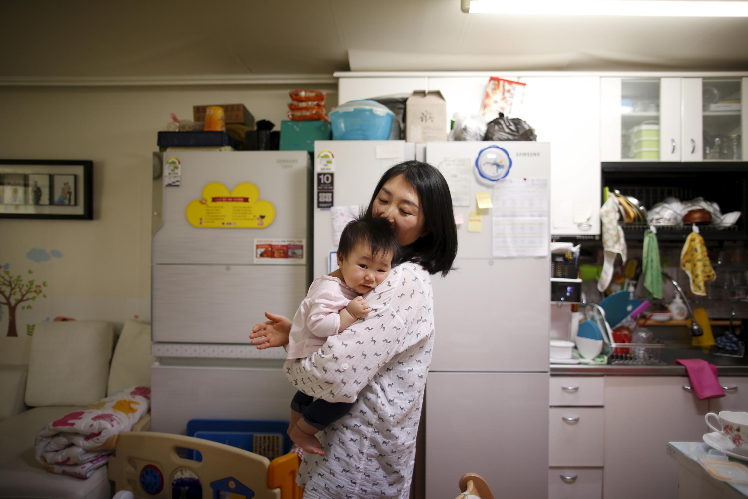 Jeong Bo-mi takes care of her baby at her home. 