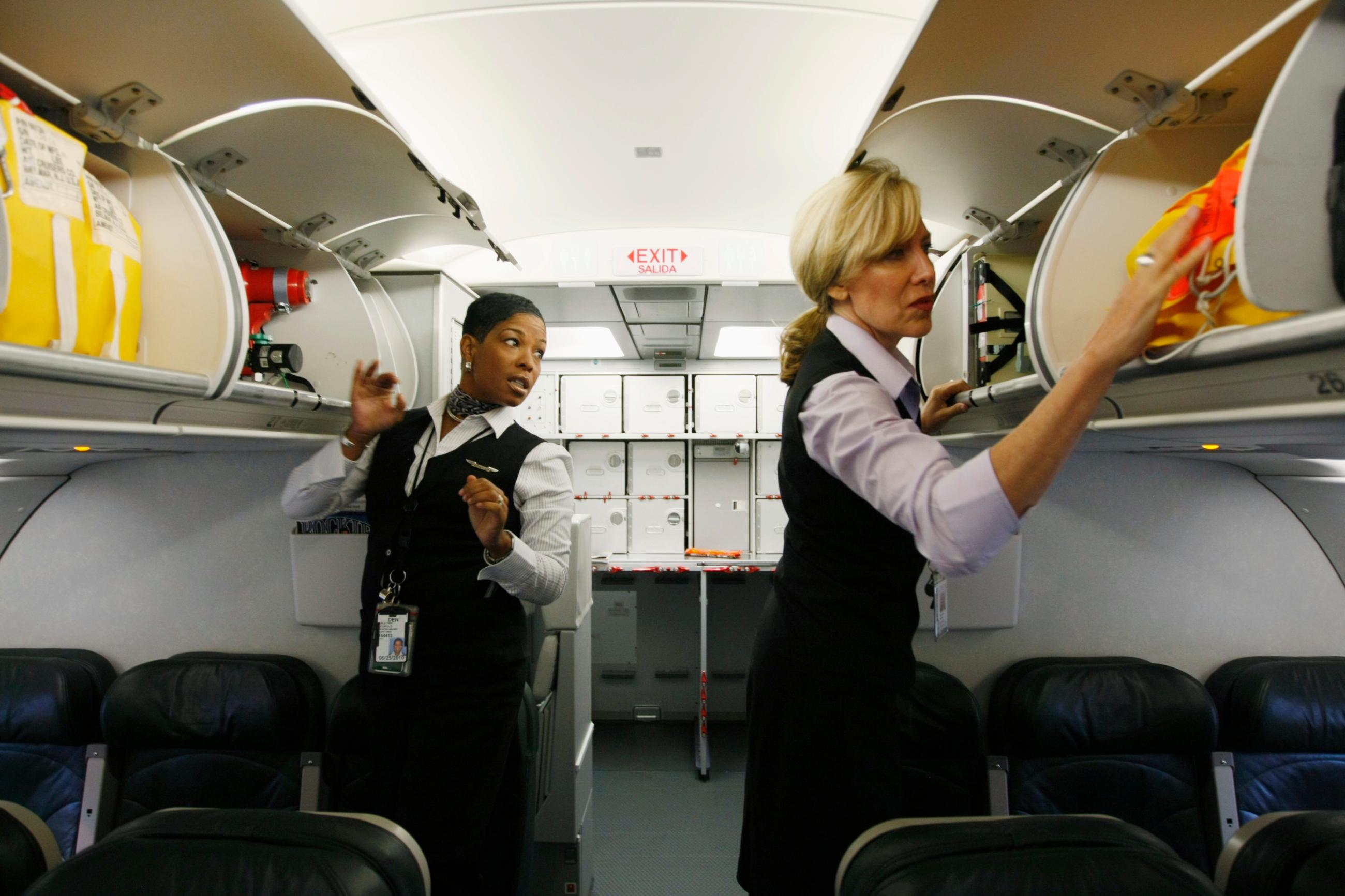 Frontier Airlines flight attendants check safety equipment