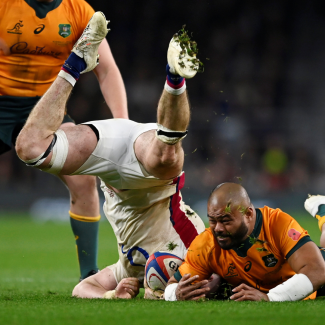 England's Tom Curry in action with Australia's Tolu Latu on the rugby pitch at Twickenham Stadium, in London, UK, on November 13, 2021.