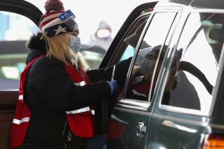 A health-care worker administers the Johnson & Johnson's coronavirus disease (COVID-19) vaccine to a person at New Hampshire Motor Speedway in Loudon, New Hampshire, on March 6, 2021.