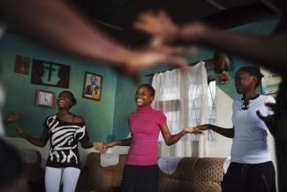 Girls play a clapping game during a weekly education on session women’s safety.
