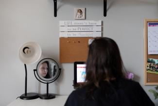 Sara Lundberg, who struggled with anxiety and depression during the COVID pandemic, is seen in her bedroom.