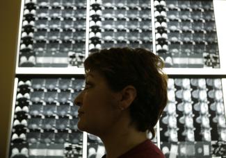 Vasiliki Kostoula, a breast cancer patient, listens to her doctor after a radiological medical examination.