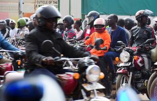 Motorbike taxis are seen in traffic jam along the Jinja Road traffic lights.