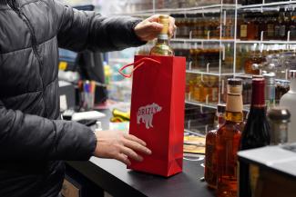 A delivery order is put together at Regina's Liquors.