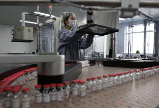 An employee works on the production line of CanSino Biologics Inc's single-dose vaccine against COVID-19