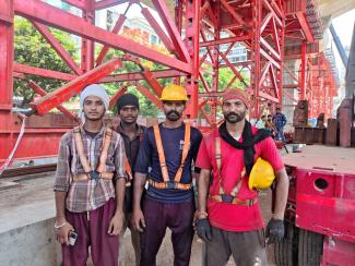 A group of construction workers stand for a photo, in Mumbai, India, June 12, 2024.