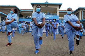 Nurses participate in a fitness program during the COVID-19 outbreak, within the Infectious Disease Unit grounds of the Kenyatta National Hospital.