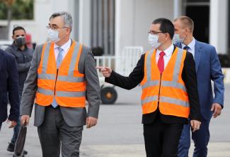 Russia’s ambassador to Venezuela Sergey Melik-Bagdasarov and Venezuela's Foreign Minister Jorge Arreaza walk during the arrival of Russia's Sputnik V vaccine, at the airport, in Caracas, Venezuela.