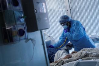 Registered Nurse LaToya Marks treats a COVID-19 positive patient at University of Arkansas for Medical Sciences.