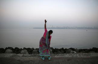 A woman exercises along the Arabian Sea.