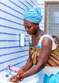 Sa-ambo Mueril, a 23-year-old patient, washes her hands in Worikambo Health Center's new facilities, Ghana. The center serves 7,000 patients annually, the majority of which are women.