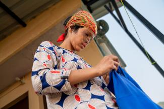 Rajkumari, a 17-year-old epilepsy and burn patient, holds a shirt.